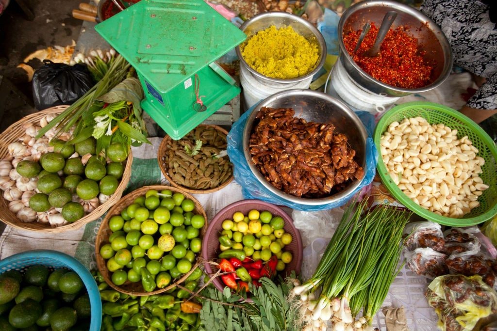 Variety of fresh produce and spices displayed at a market stall.