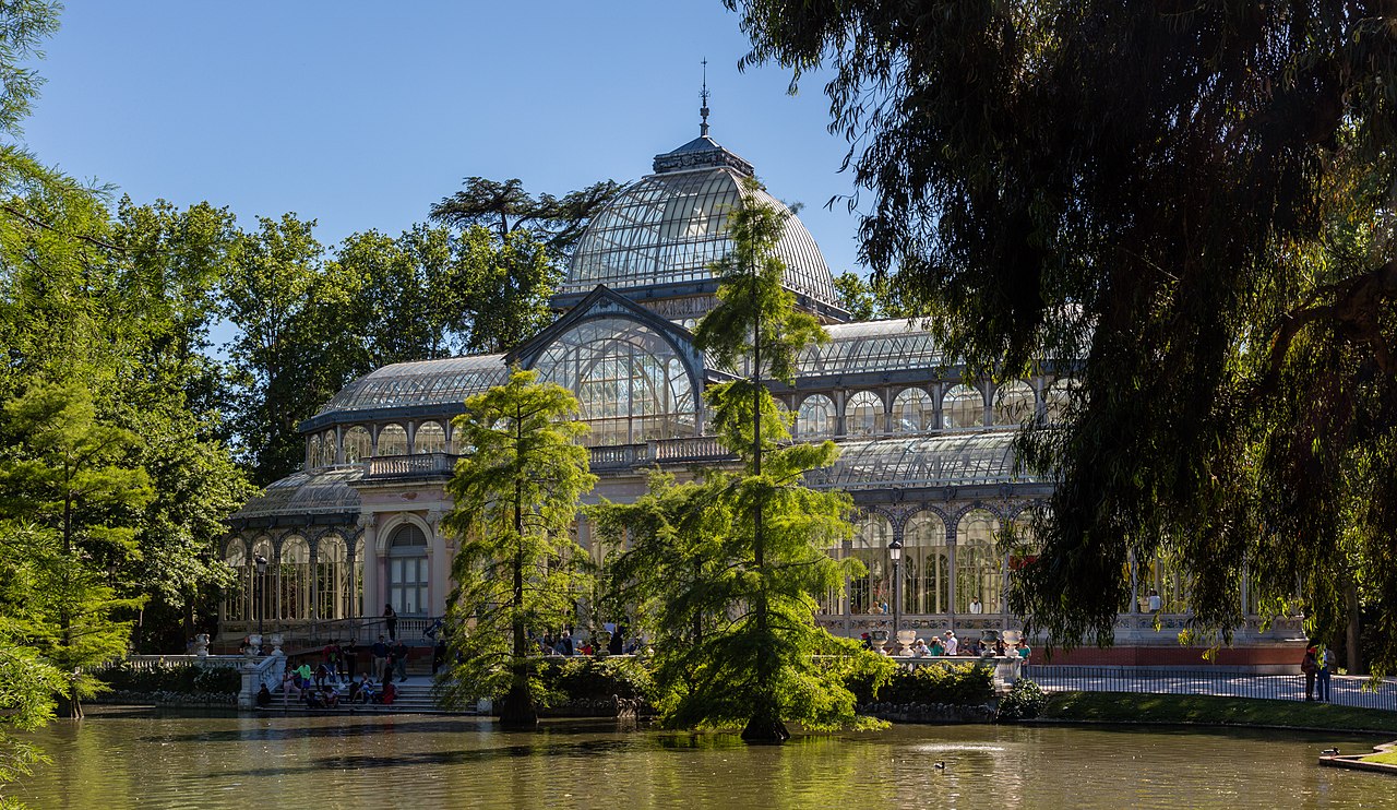 The glass and iron Palacio de Cristal reflected in its pond in Madrid's Retiro park.