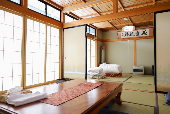 Traditional Japanese tatami room with sliding paper doors and a low wooden table