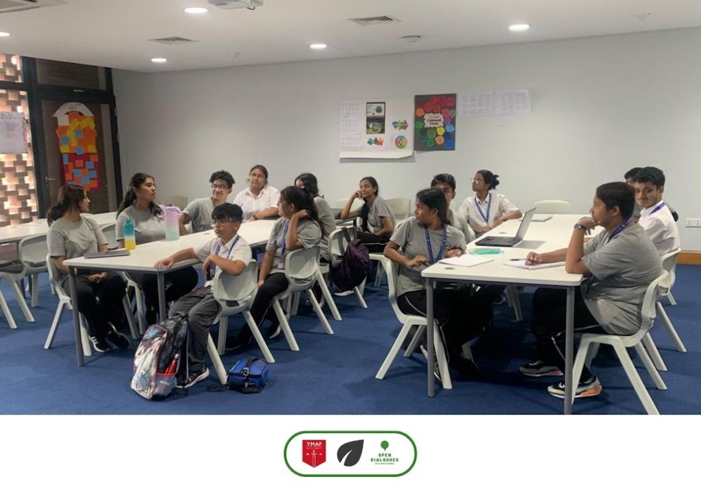 Arun with local volunteers in a classroom setting.