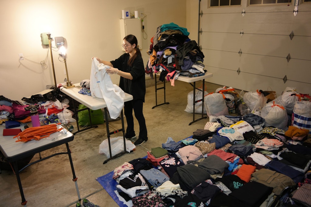 Audrey sorting clothes for her clothing drive.