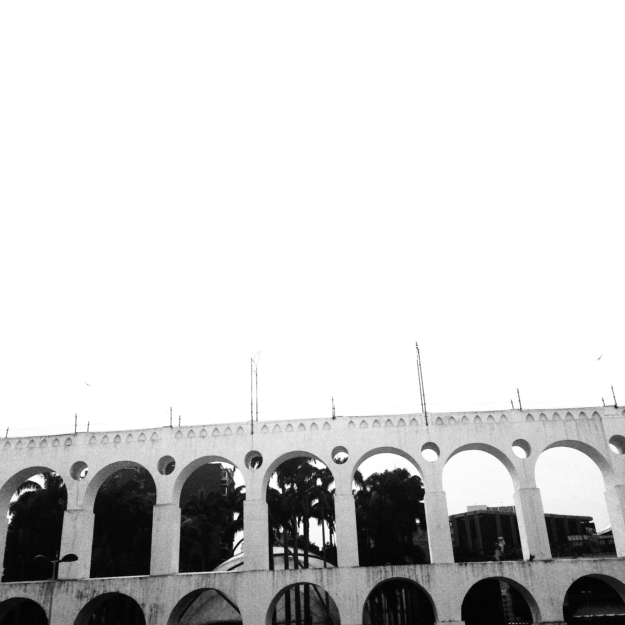 The double-tiered stone arches of the Arcos da Lapa aqueduct in Rio de Janeiro's historic center.