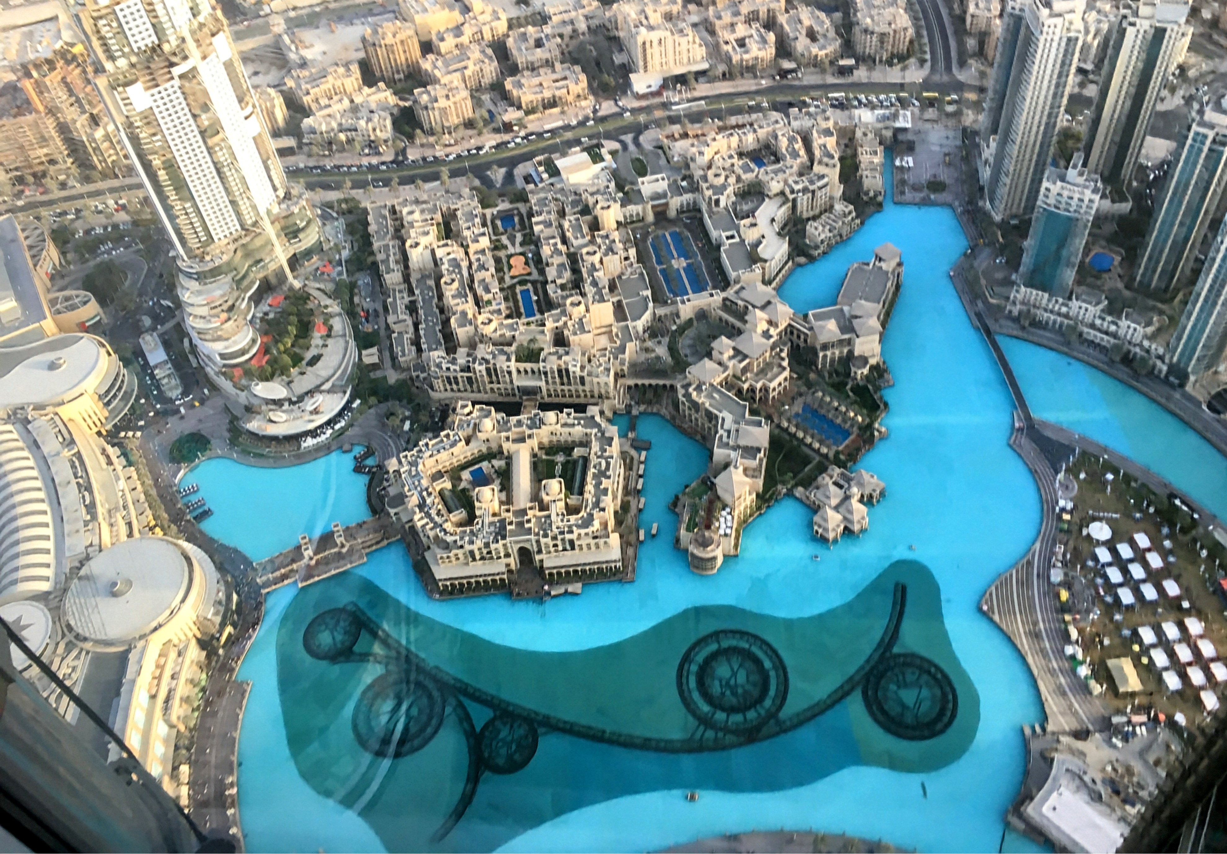 Aerial view of Dubai’s urban landscape with skyscrapers and canals around the Dubai Fountain