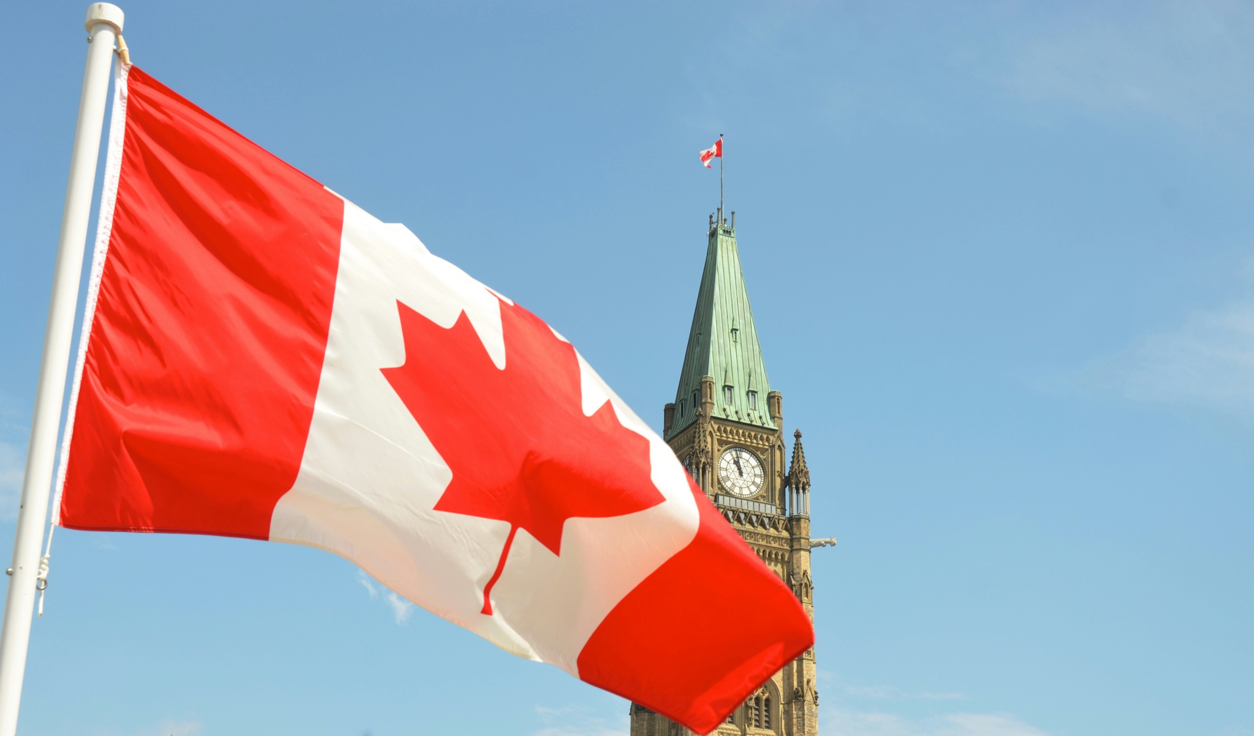 The Canadian flag flies before the Peace Tower on Parliament Hill in Ottawa.