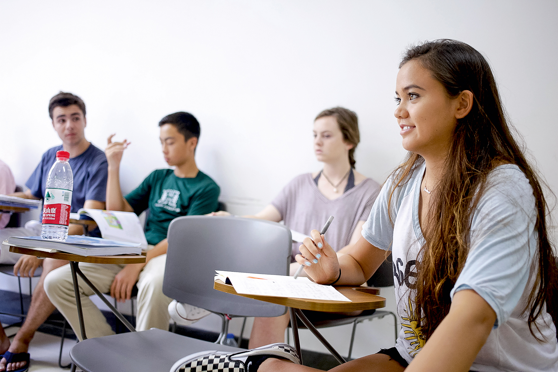 Students sit at desks taking notes during a Spanish class