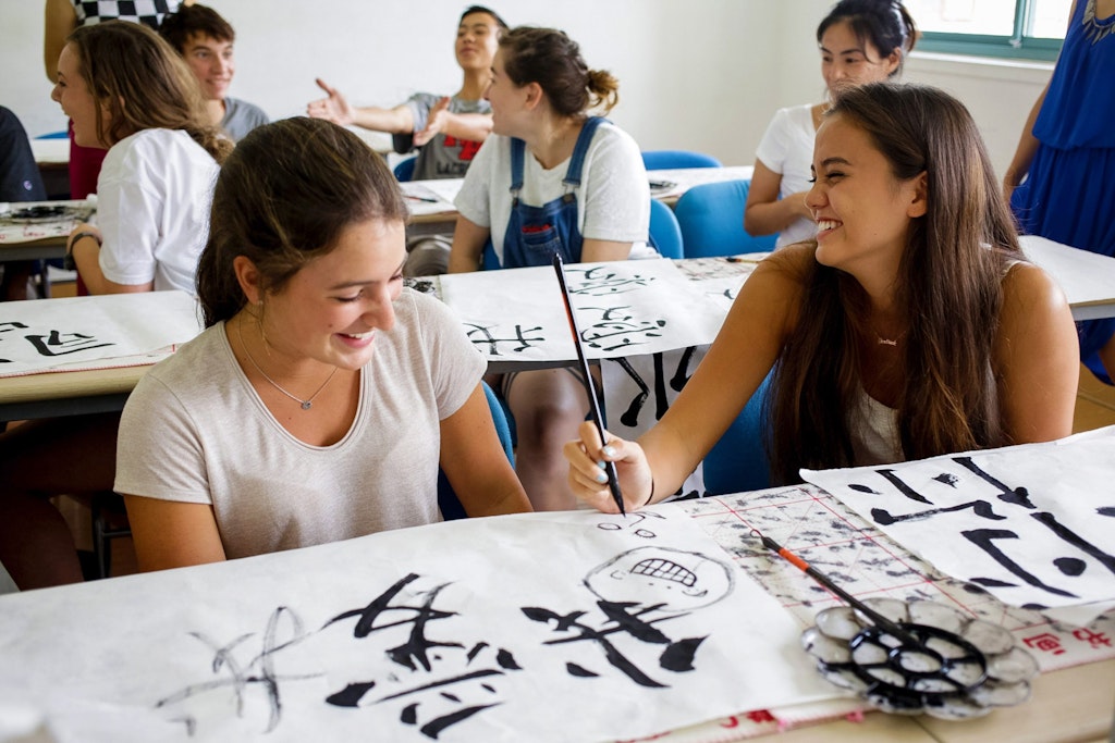 A classroom full of students learning how to write Mandarin.