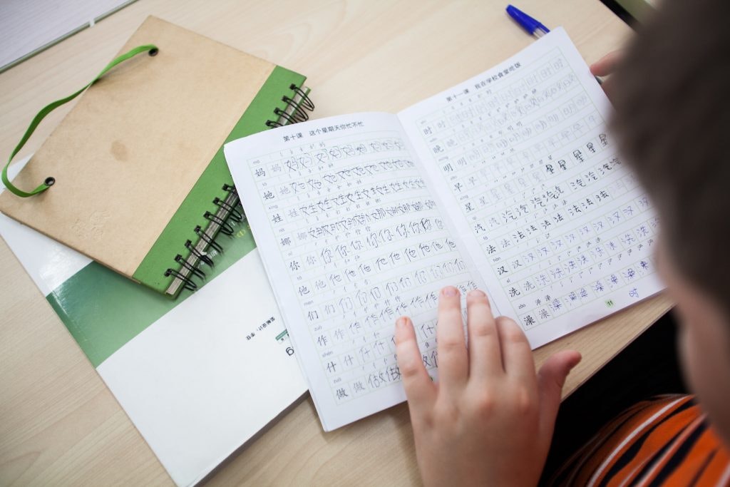 Child learns how to write a new language.
