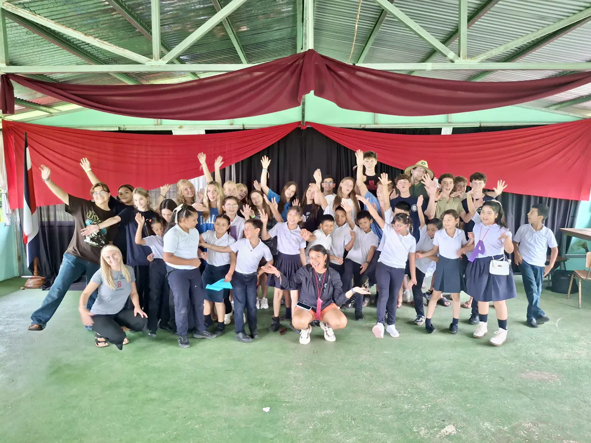 A Rustic Pathways group and Costa Rican schoolchildren under a pavilion