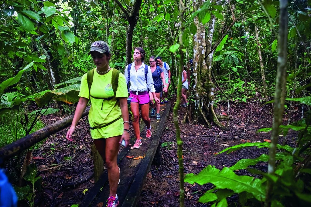 A group of students trekking through the rain forest in COsta Rica on an adventure teen tour abroad.