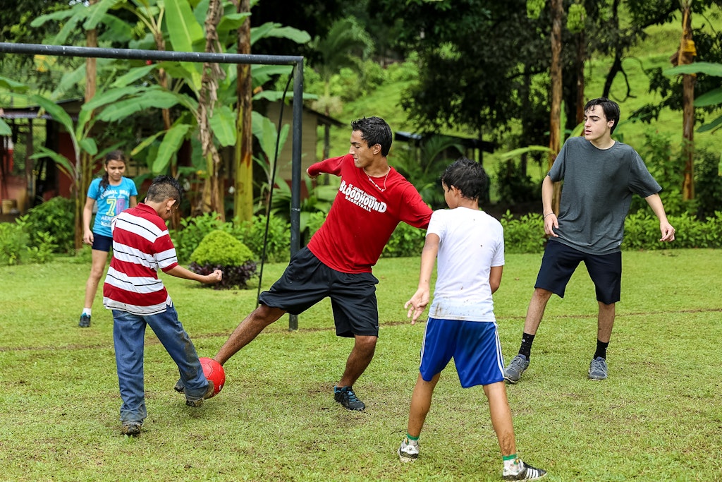 In between activities, students play a game of soccer with local children and fellow travelers.