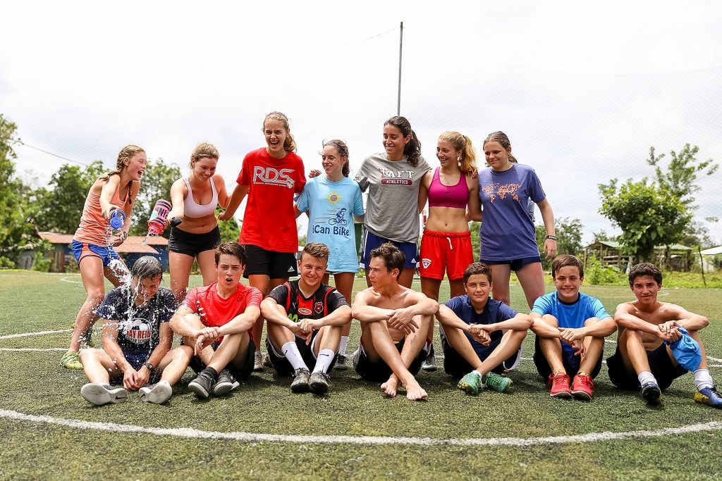 Youth soccer team having fun on the field after a match.