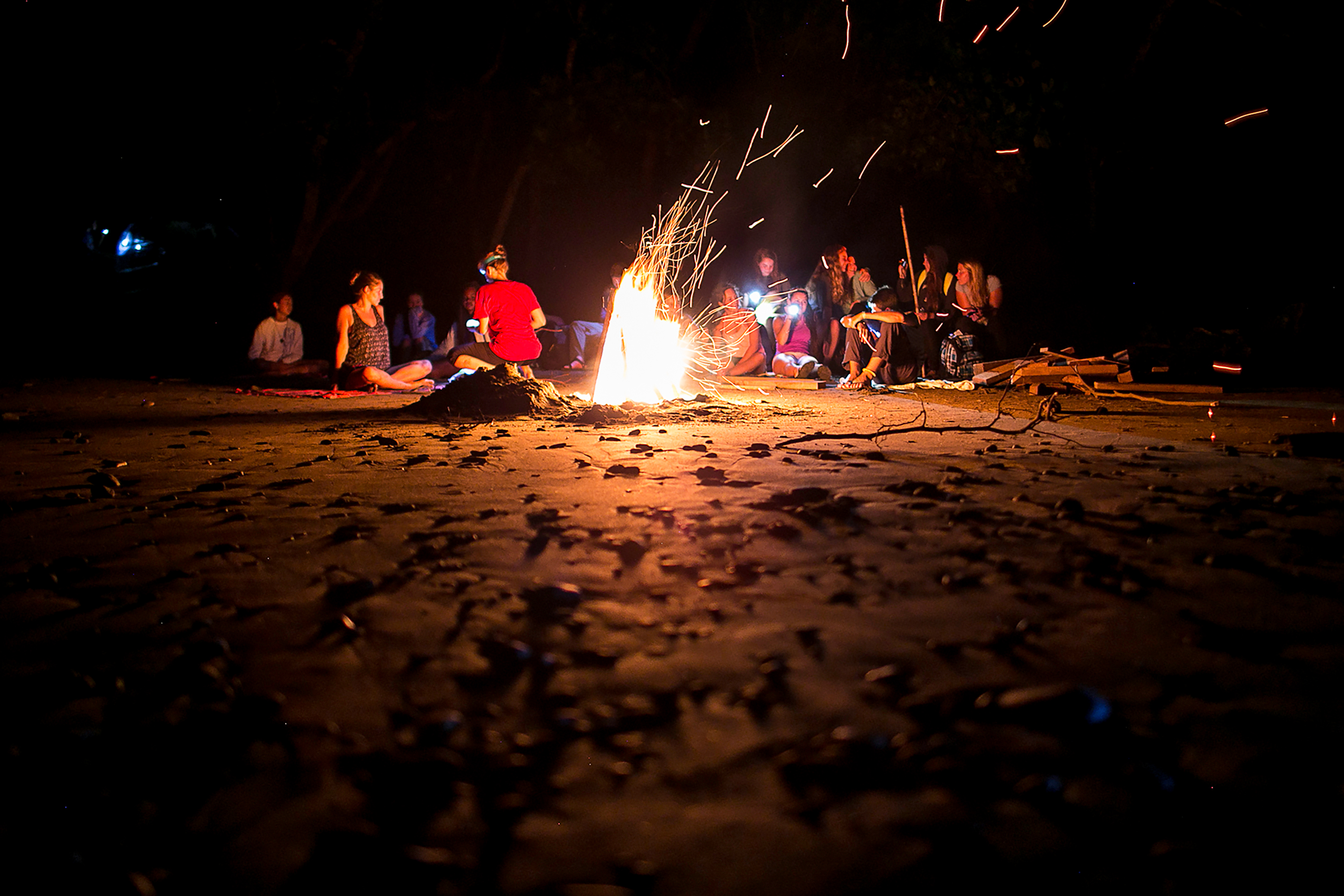 Picture of students gathered around a campfire.