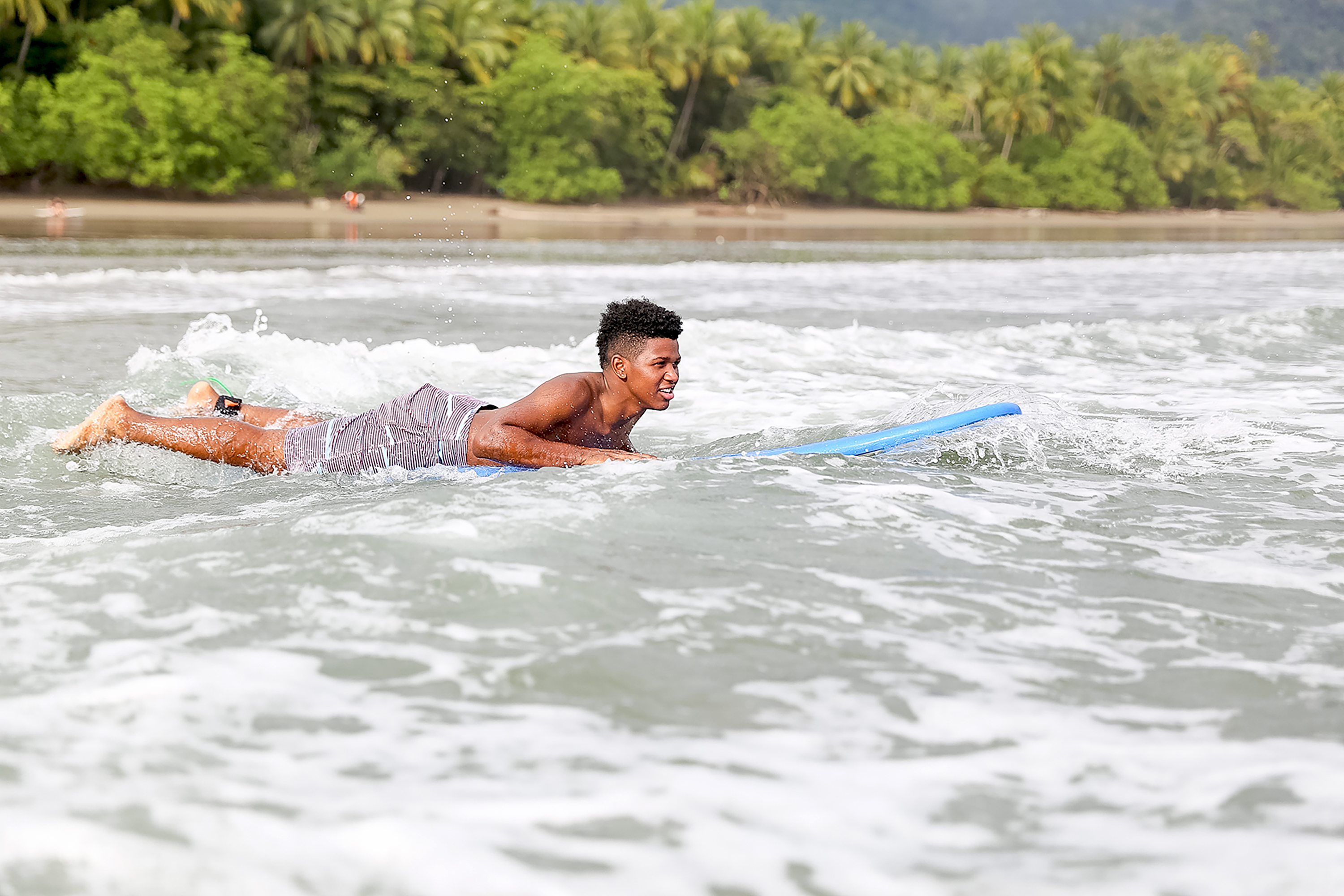 Teen surfing on Costa Rica's Pacific coast during Rustic Pathways program