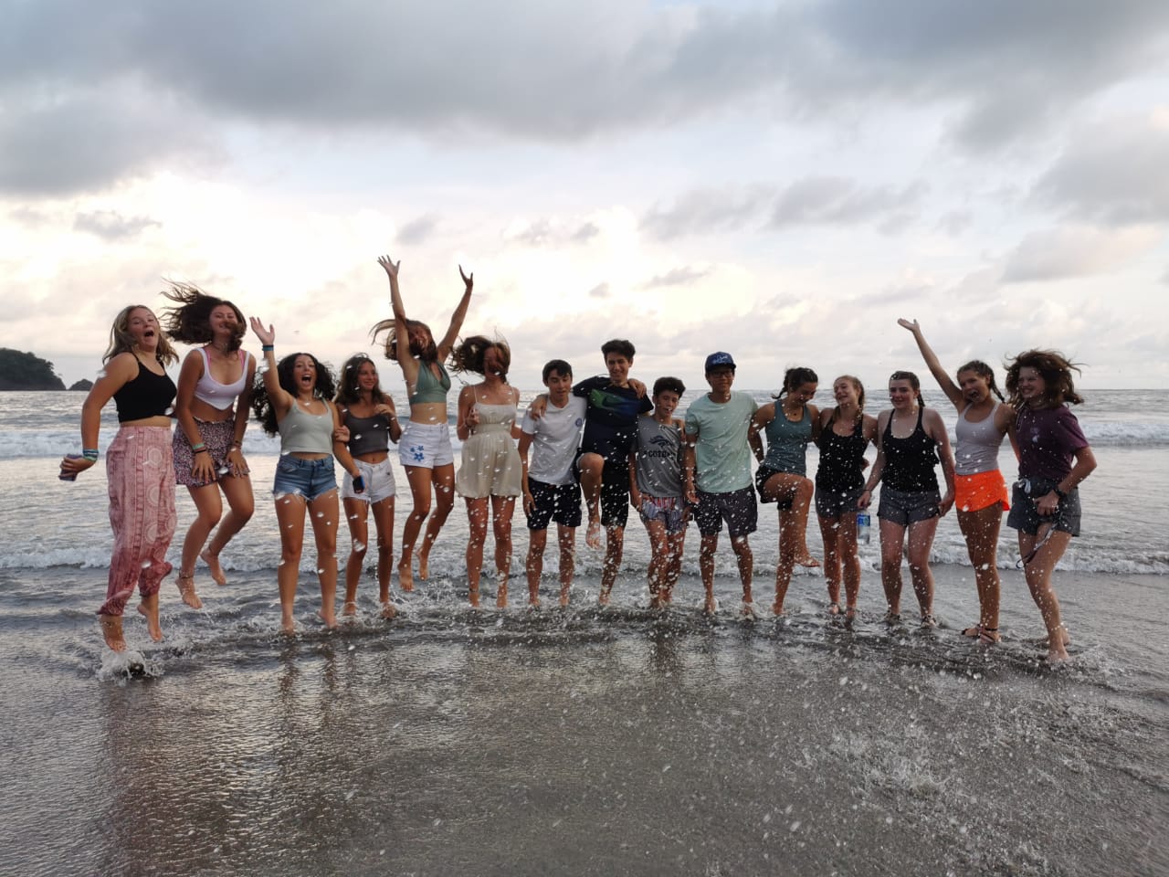 Student Travel Programs in Latin America: Students jumping on a beach in Costa Rica