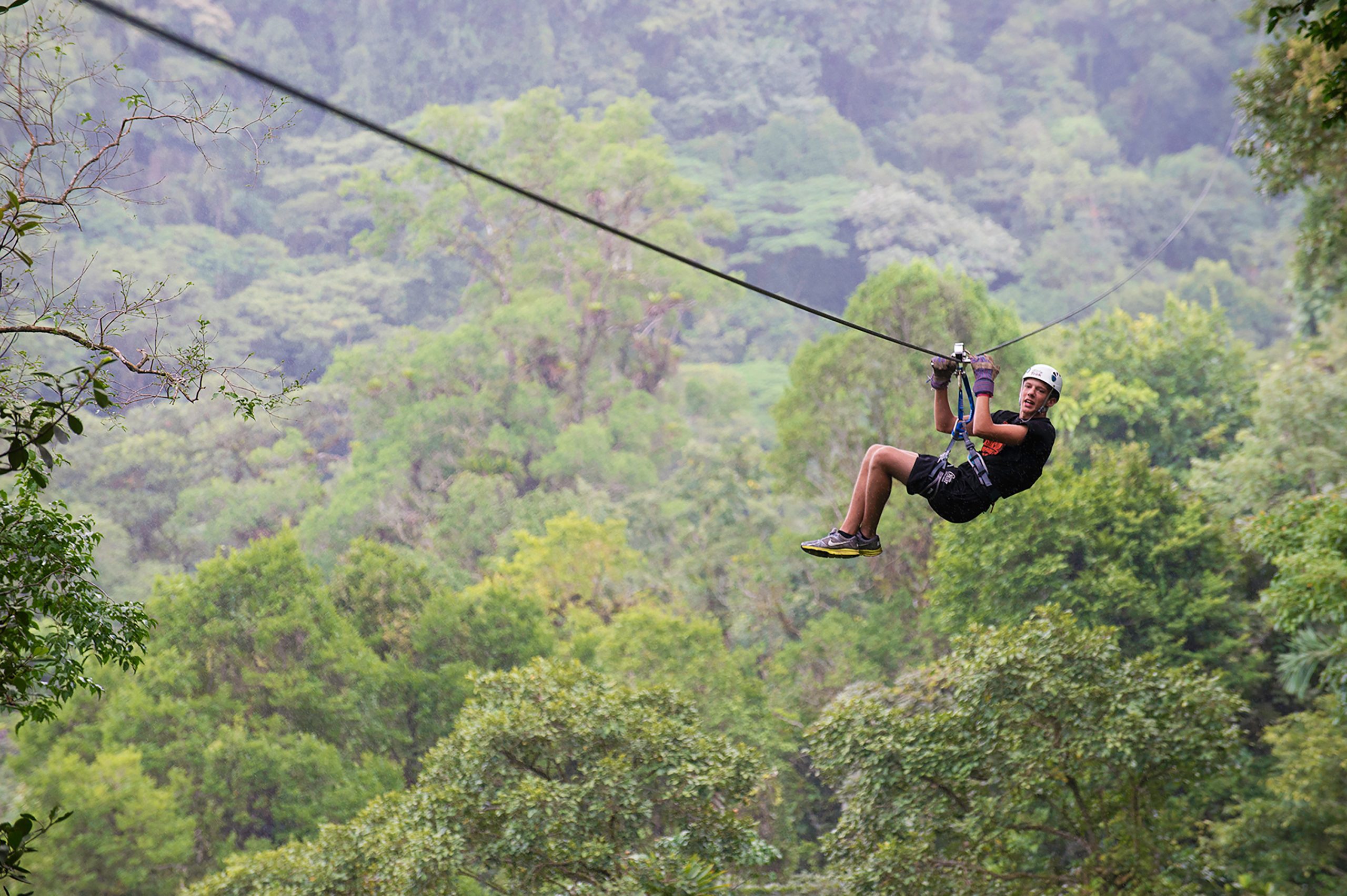 Student ziplining through the rainforest as part of Rustic Pathways summer volunteer abroad programs