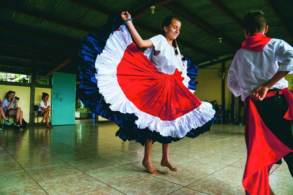 Students watching a traditional cultural dance performance as part of Rustic Pathways first-time volunteer abroad program
