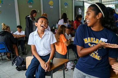 a teen traveler practices speaking Spanish to a local student during a teen travel program in Costa Rica