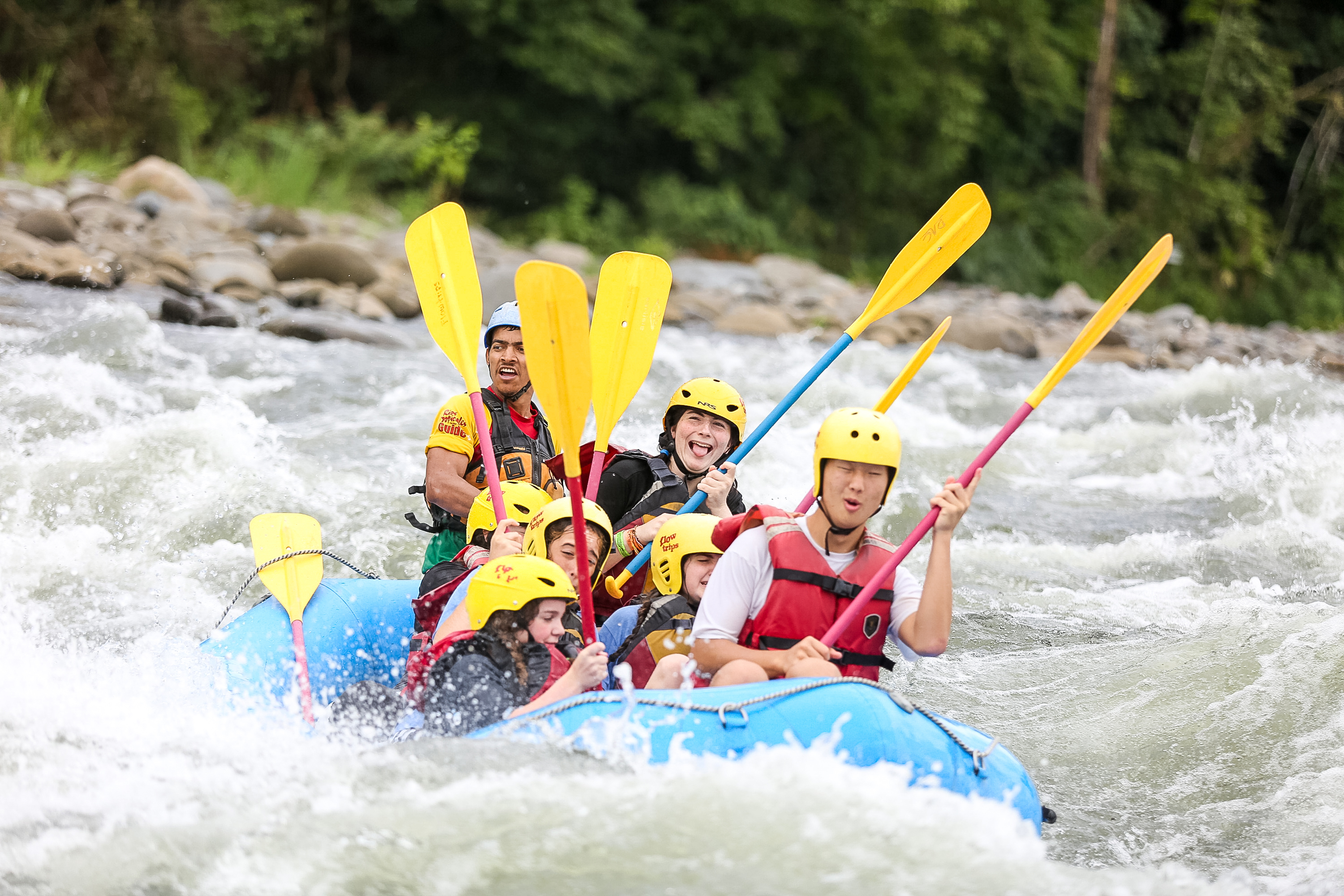 Students whitewater rafting down a river on a teen tour in Costa Rica.