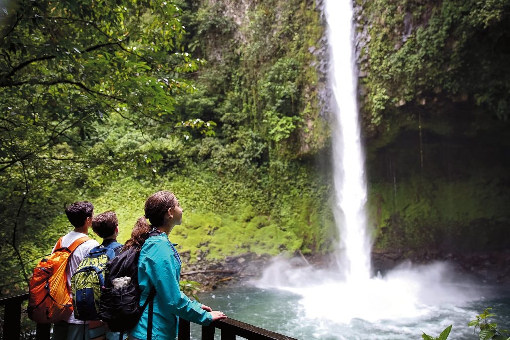 Three students in the nature, exploring a waterfall. #teentravel