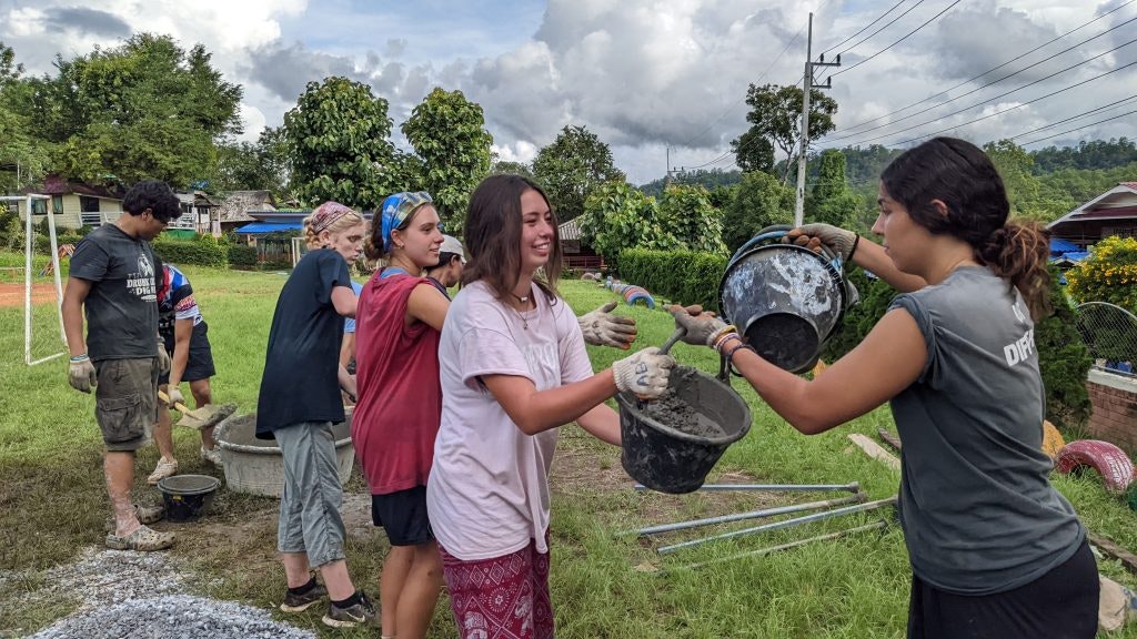 Students working on a service project during a young adult group travel program.