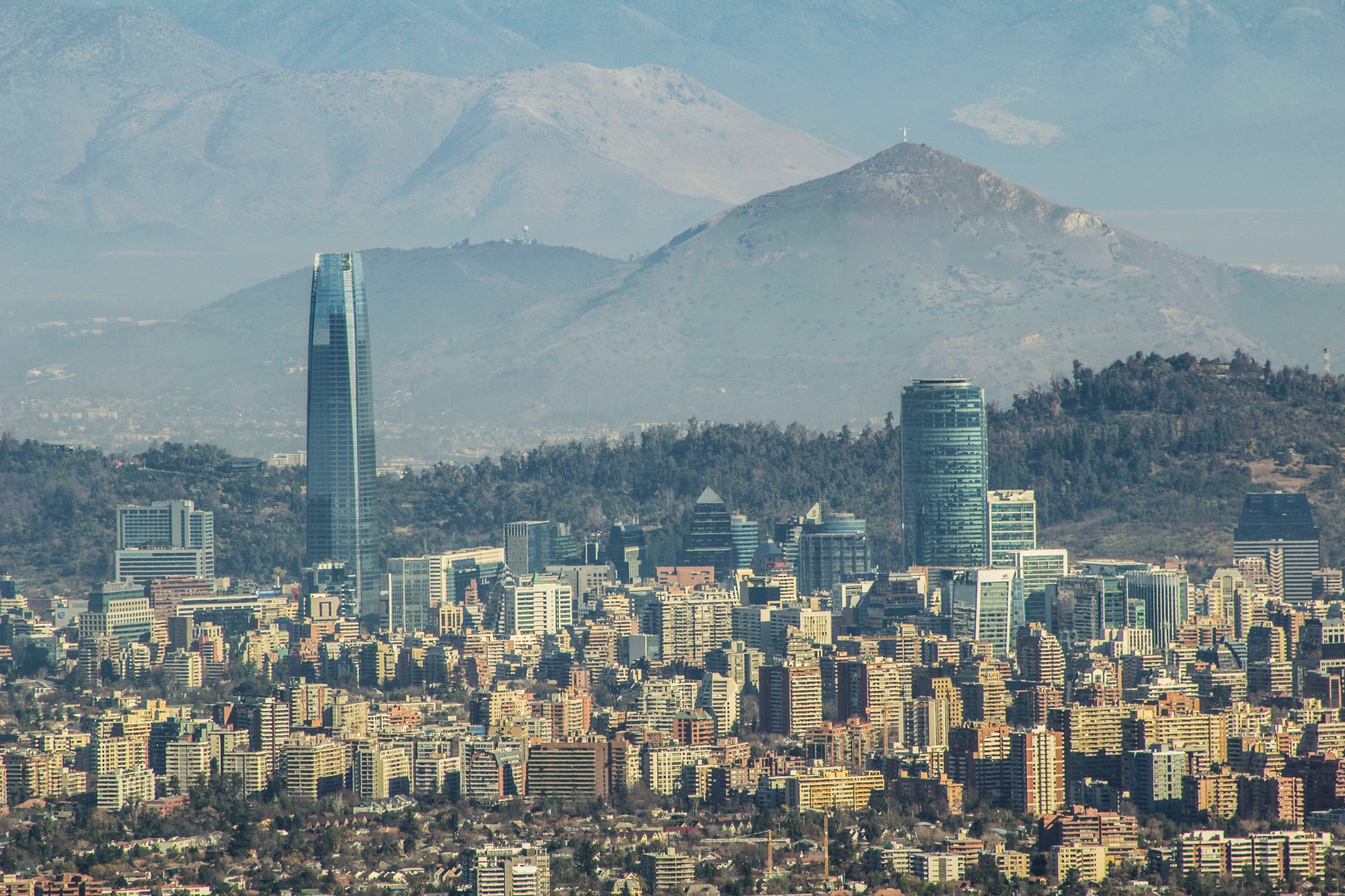 Landscape view of urban city, Las Condes, in Peru with many apartment buildings and large mountains in the background.