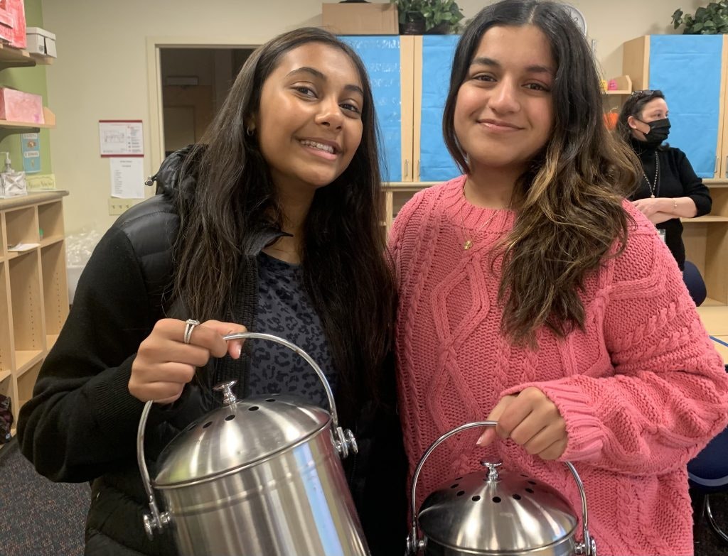 Students in Rustic Pathways' Climate Leaders Fellowship program promote the use of compost bins at a school Melville, New York.