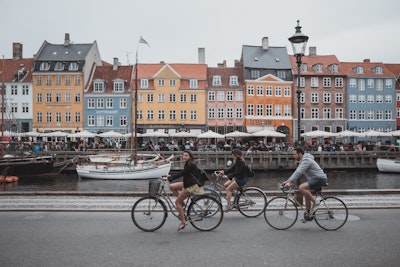 teen travelers cycling through the streets of Denmark during a teen travel program