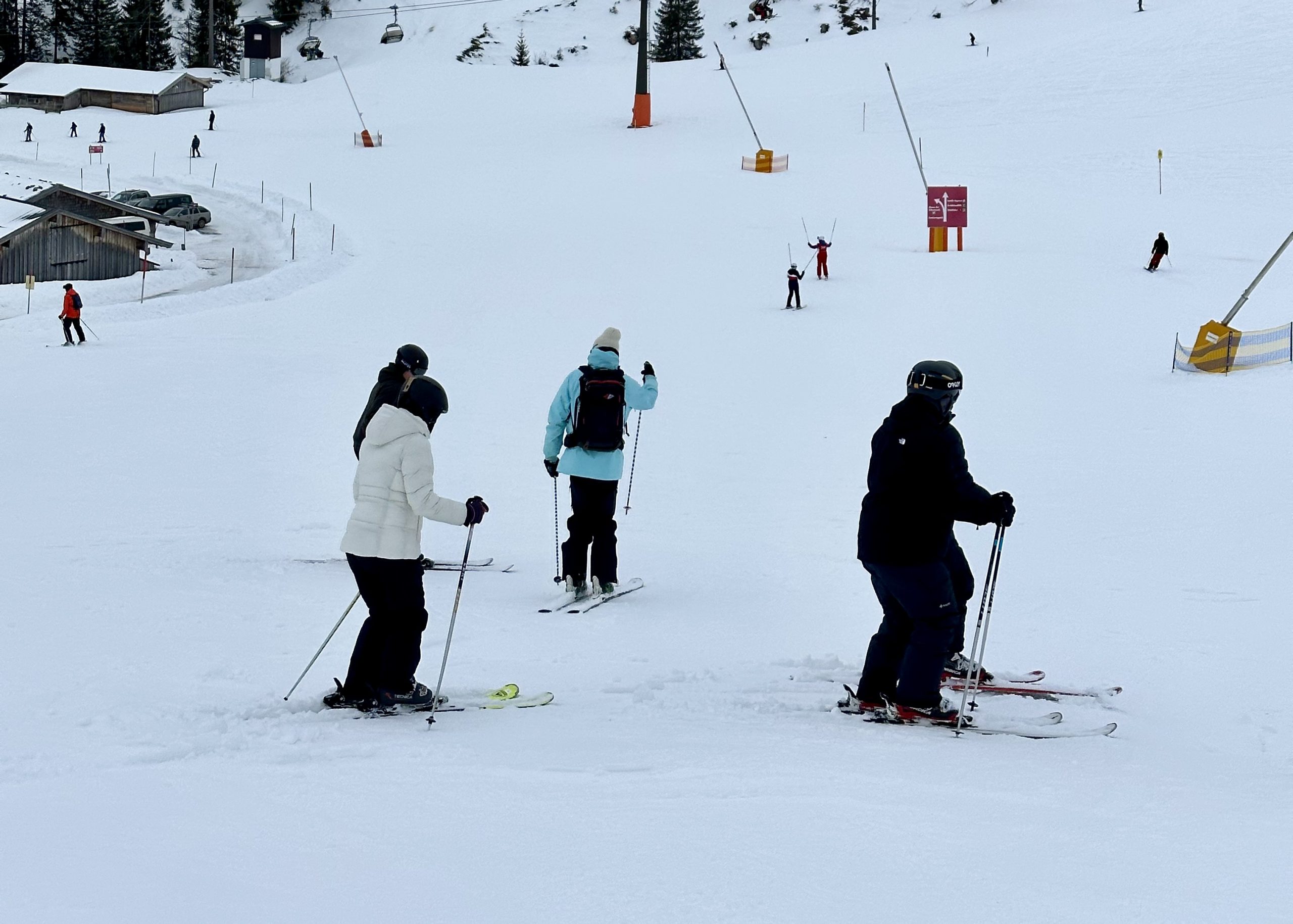Teens ski down a snowy slope in the Alps