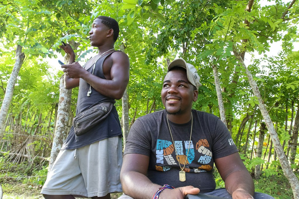Volunteers smiling and connecting in a tropical setting during a Rustic Pathways short-term volunteer abroad experience.