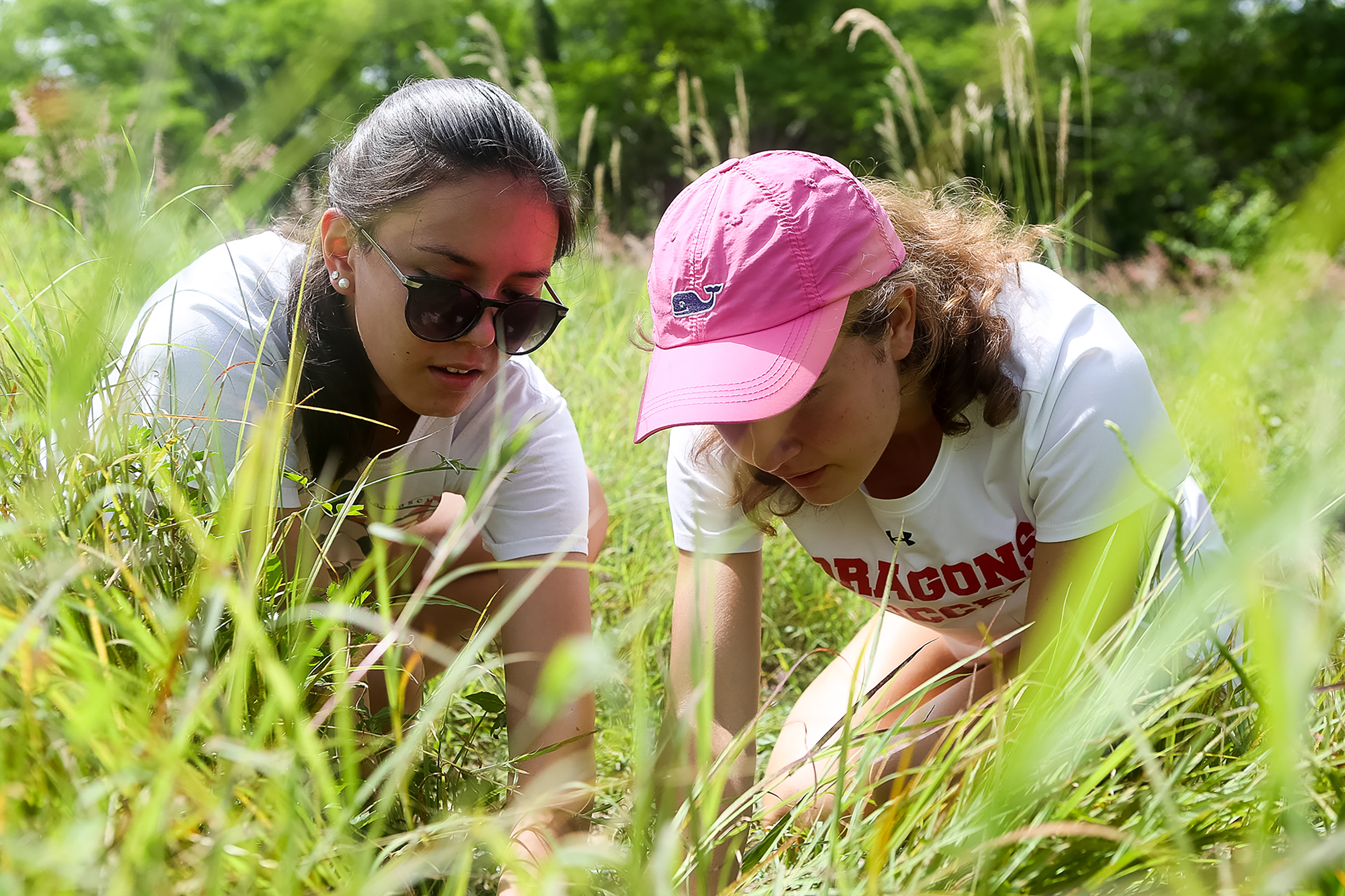 Closeup of two students working to restore a mangrove eco-system in the Dominican Republic.