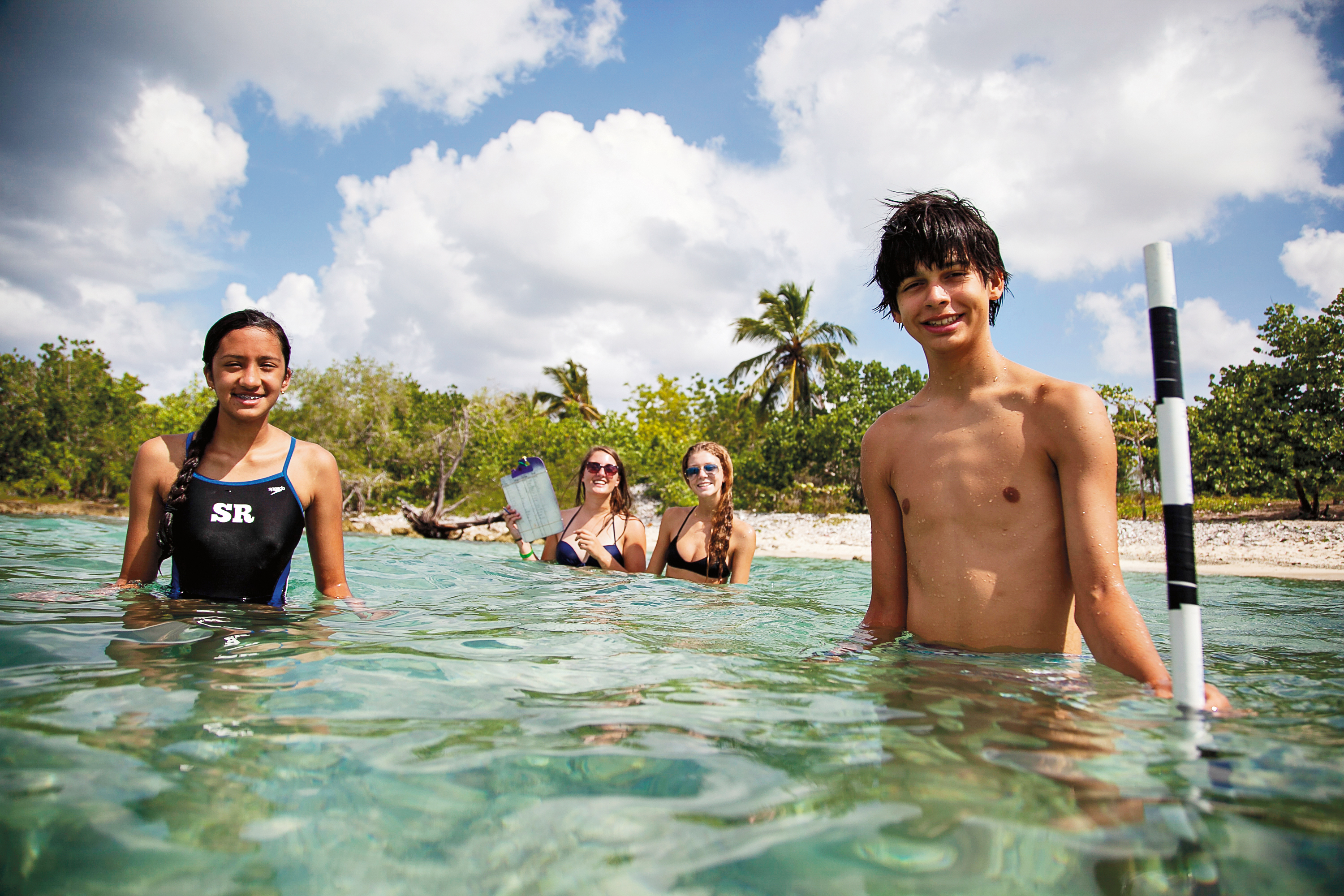 Teen students on a Caribbean beach during the Dominican Republic Beachside Service program