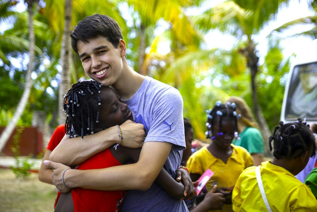 Teen volunteer program leader supporting local youth during a community service experience in the Dominican Republic.