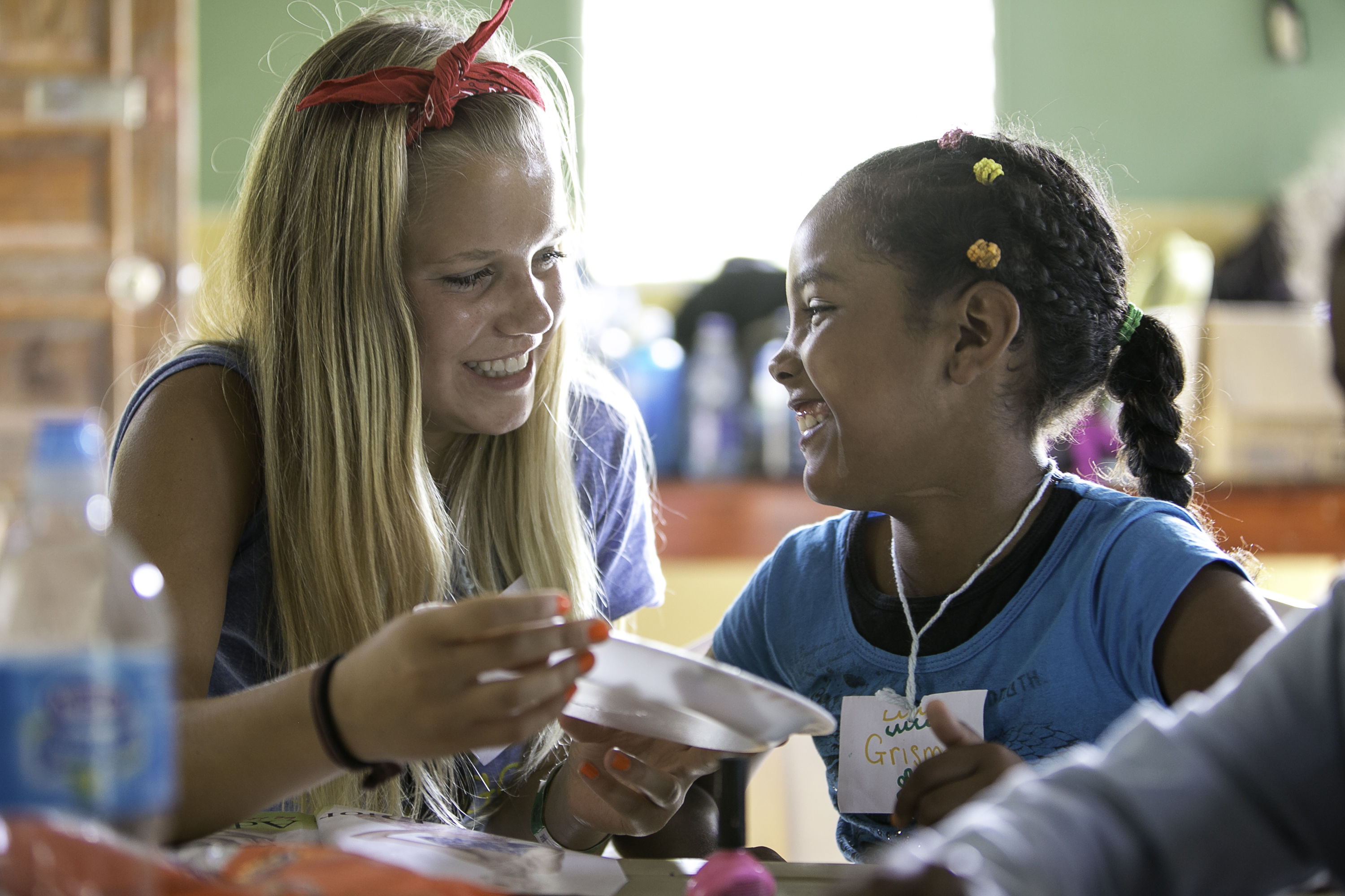 A student shares a laugh with a local child during a community visit