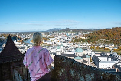 Student overlooking a European cityscape during a teen tour in Portugal, Greece, Italy, and Spain.