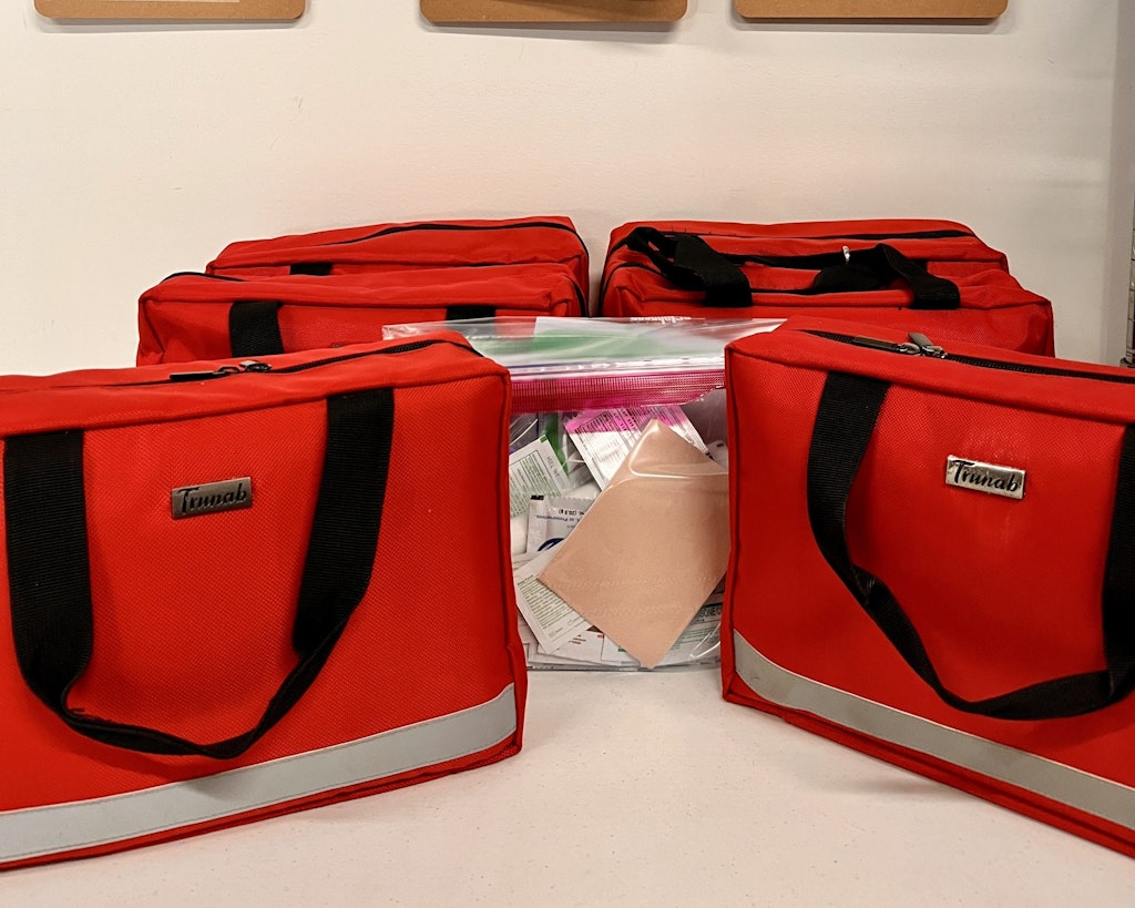 Rustic Pathways program leader med kits lined up for distribution before program departure