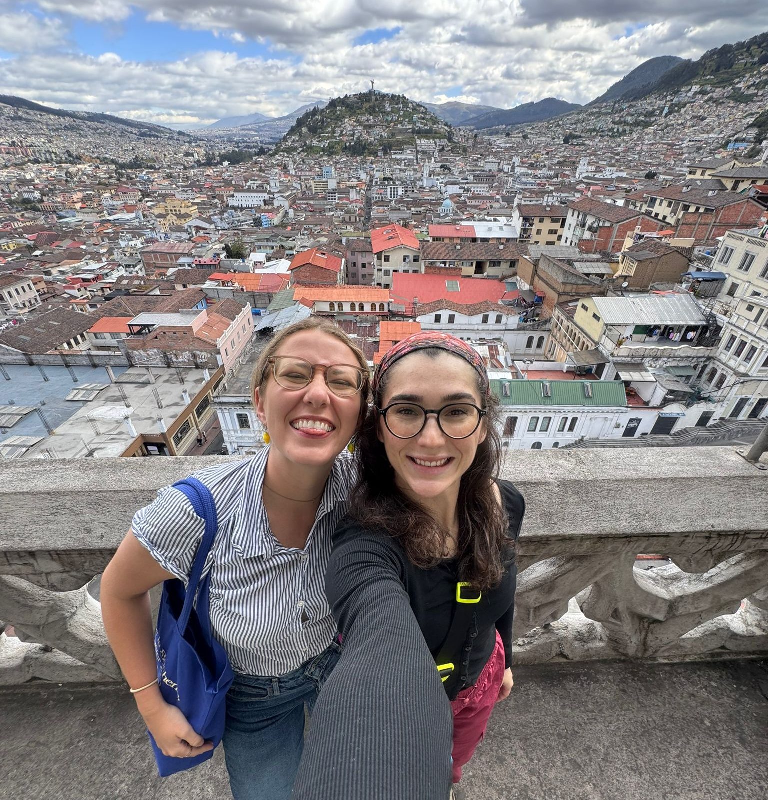 Two students take a selfie overlooking Quito, Ecuador