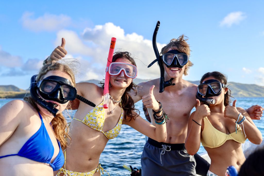 Teen travelers snorkeling in Fiji.