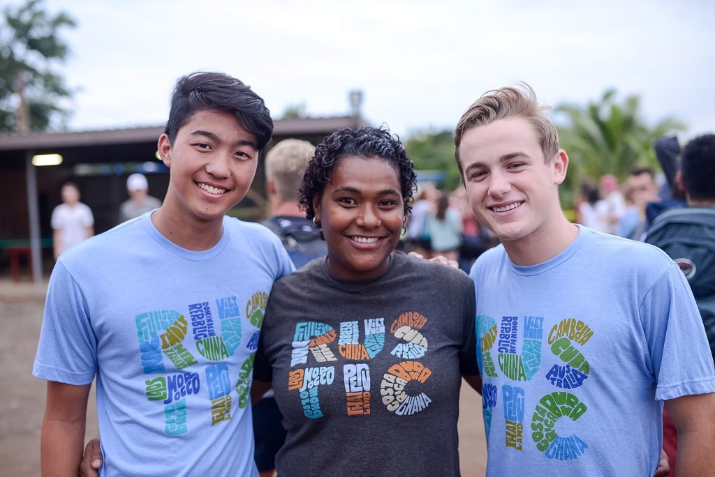 Students and local leader smiling together during a Rustic Pathways teen tour in Fiji.