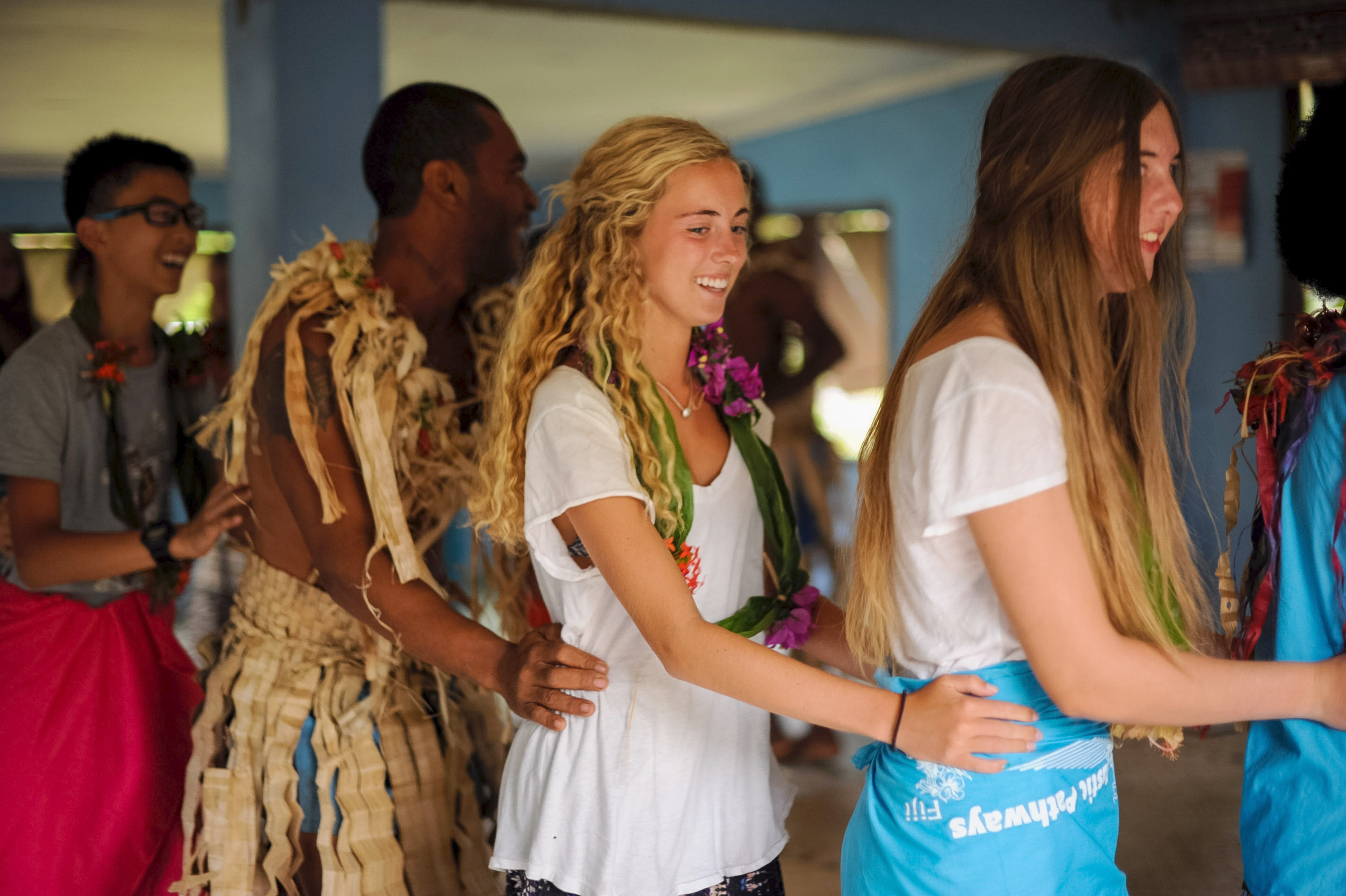 Students join local performers in traditional dress during a dance at a Fijian welcome ceremony