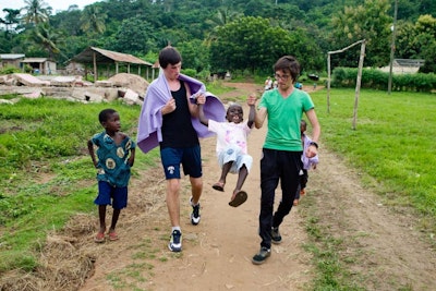 Volunteer in Africa students play with local children during a volunteer abroad trip to Ghana
