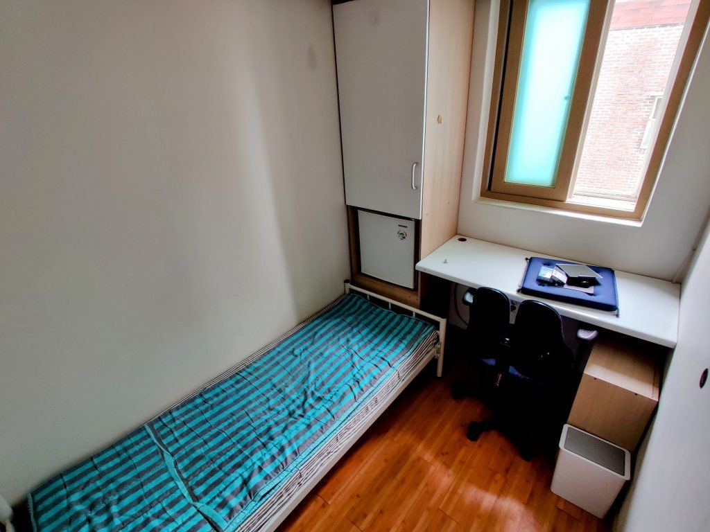Goshiwon accommodation in South Korea, offering compact living spaces for students and job seekers. Contains only a bed, desk, and window.