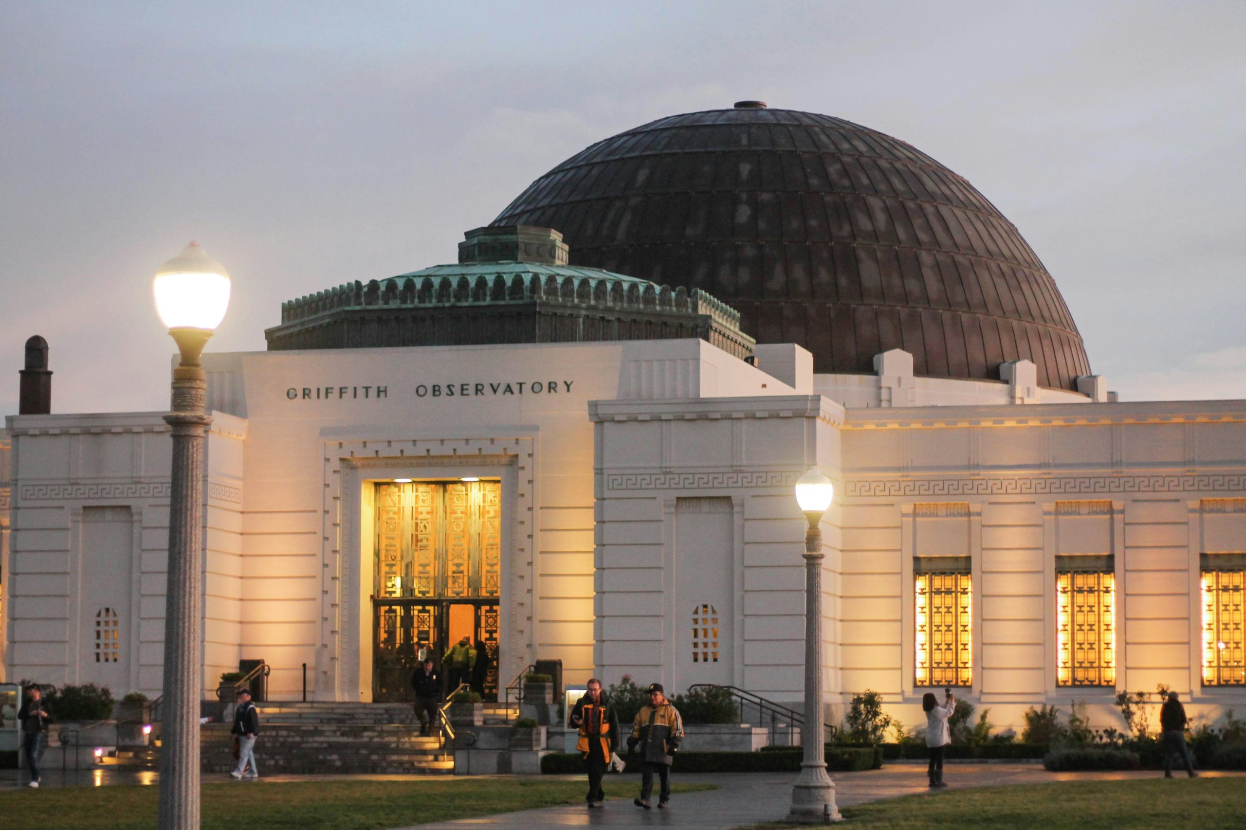 Griffith Observatory at dusk, illuminated against the evening sky.