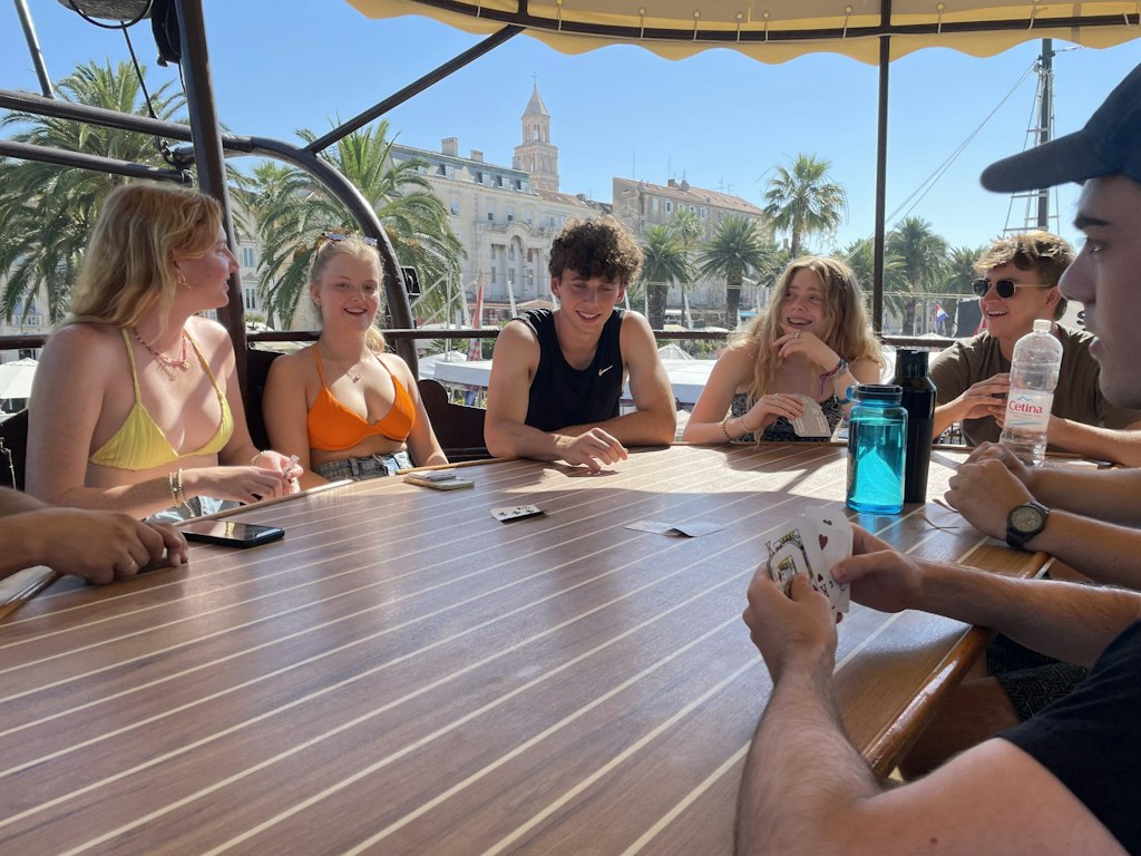 Students relaxing together on a boat after a day of service during Rustic Pathways spring break volunteer abroad program