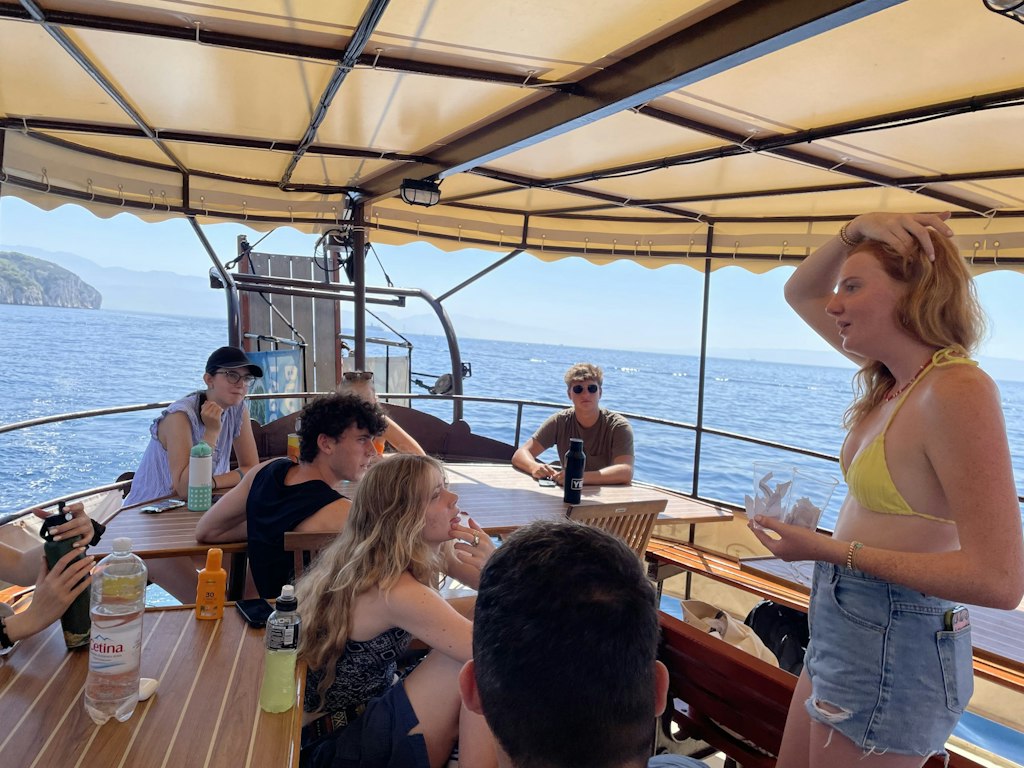 Students on a boat during Rustic Pathways spring break volunteer abroad trip learning about marine conservation