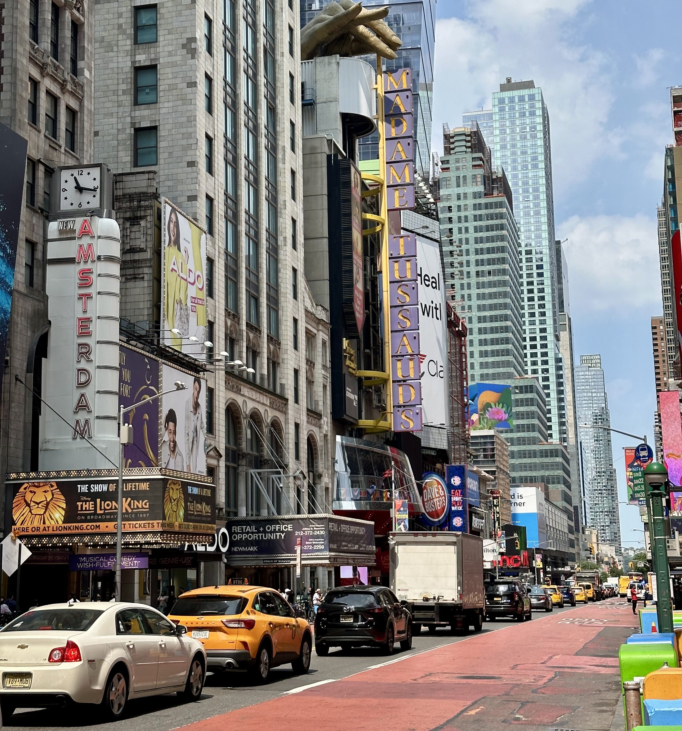 View of Times Square featuring the Madame Tussauds entrance and nearby Broadway signs.