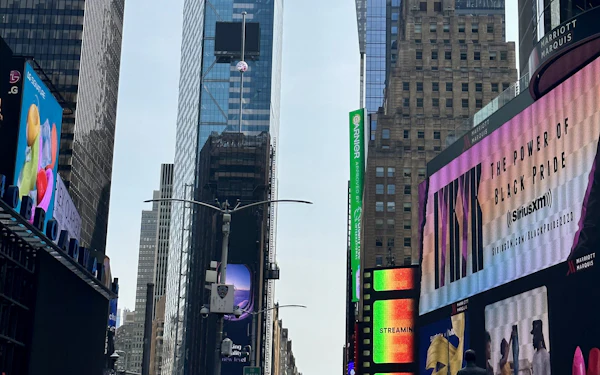 Times Square screens above the crowd at street level.