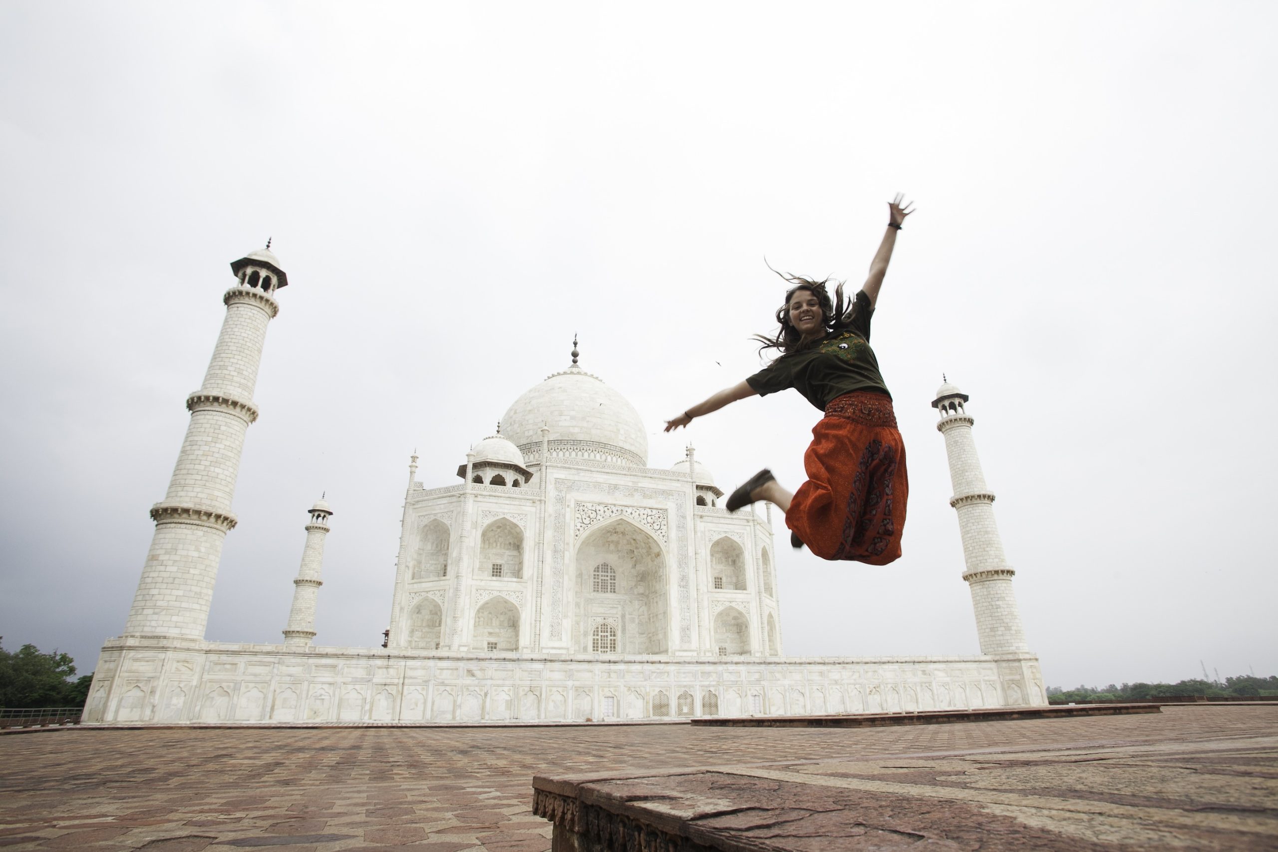 A student jumps for joy in front of the Taj Mahal in India