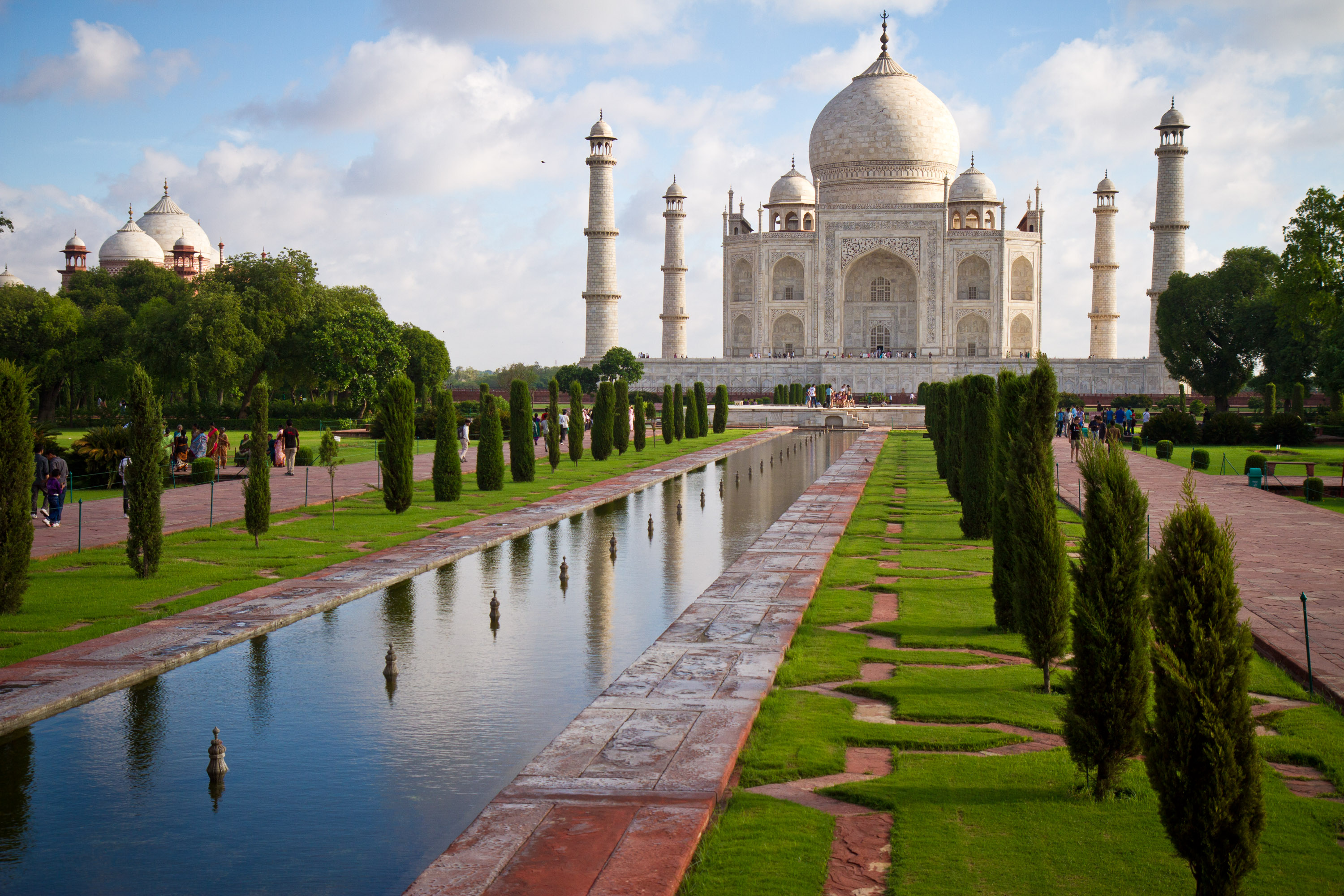 On this school trip, the Taj Mahal reflects in a long garden pool lined with manicured trees