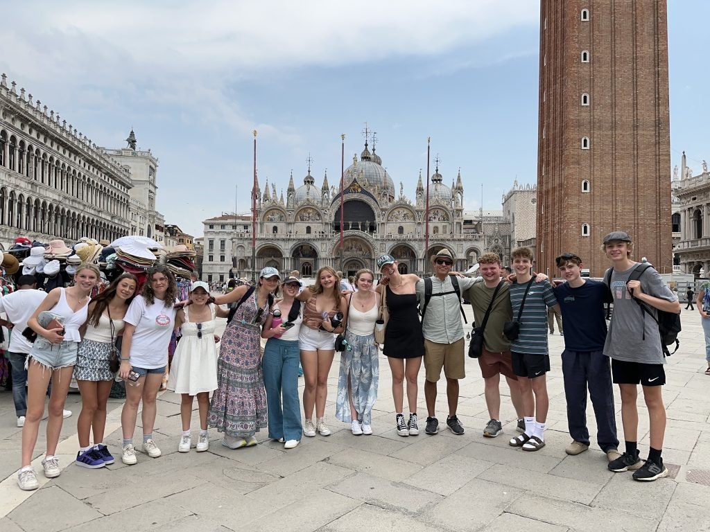 Group of students visiting a historical site in Italy or Spain.