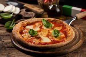 fun facts about Italian food - pizza Margherita on a wooden table